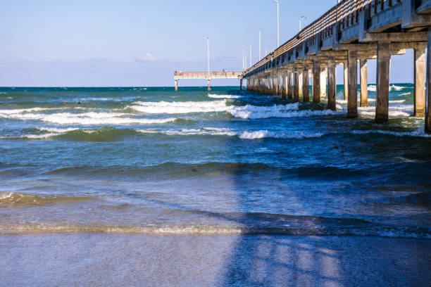 Corpus Christi , Texas - Port Aransas Pier with waves crashing on the beach of Padre Island, Texas